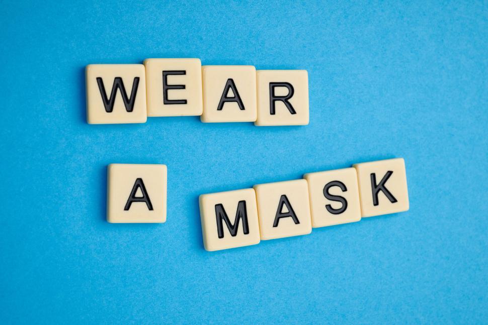 Free Image of The phrase wear a mask displayed in black letter tiles 