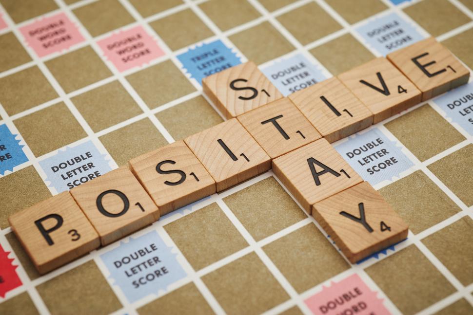 Free Image of Scrabble tiles spelling out  positive  and  say  on board 