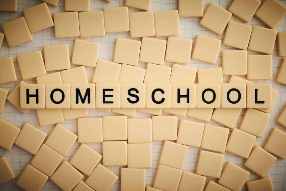 Free Image of Plastic tiles form the word  HOMESCHOOL  on a board. 