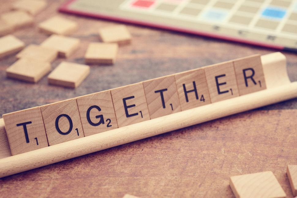 Free Image of Wooden letter tiles forming the word  together  on stand. 