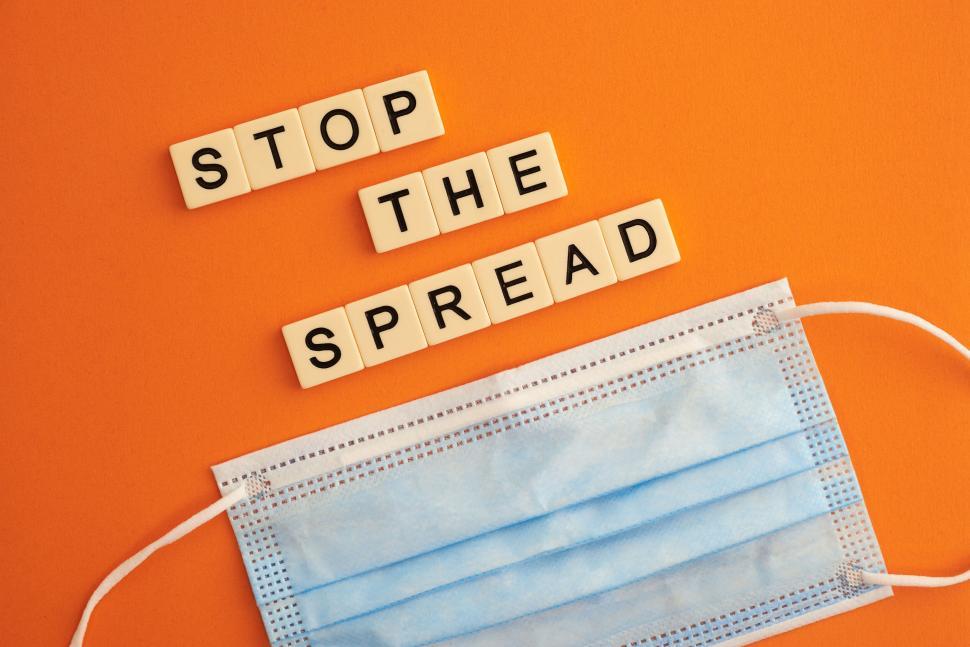 Free Image of Scrabble tiles spelling  stop the spread  with mask. 