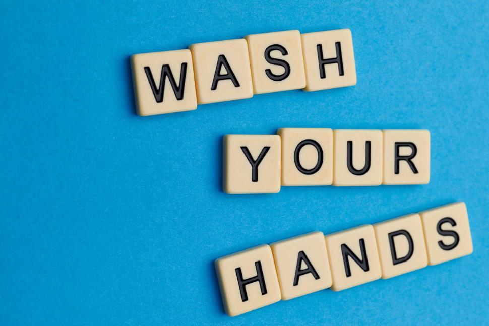 Free Image of Scrabble tiles spelling out WASH YOUR HANDS on blue background 