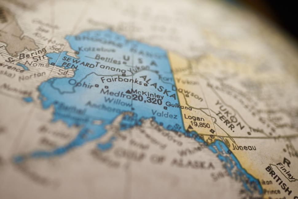 Free Image of Alaska highlighted on a globe along with surrounding areas. 