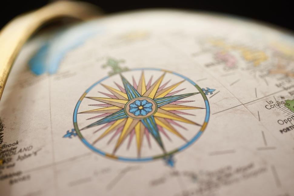 Free Image of Vintage globe showing colorful compass rose close-up. 