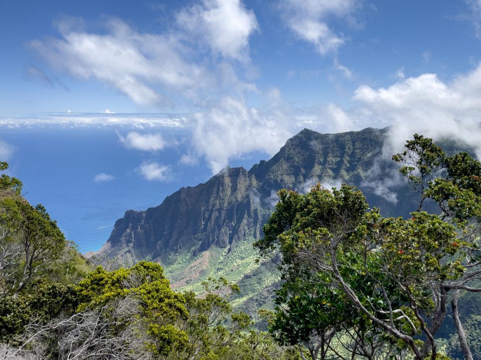 Free Image of Mountainous landscape with cloudy sky and ocean view 