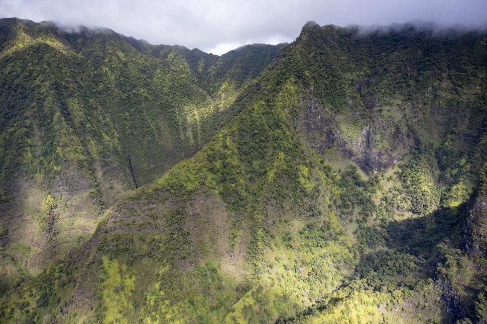 Free Image of Aerial view of lush green mountainous terrain 