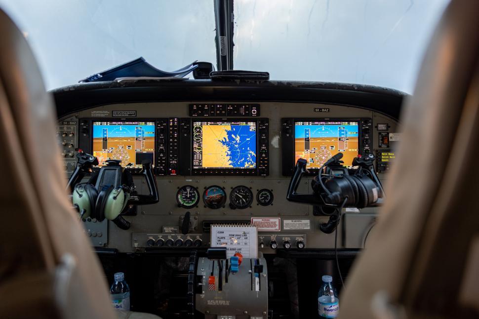 Free Image of Cockpit view inside an airplane with digital displays 
