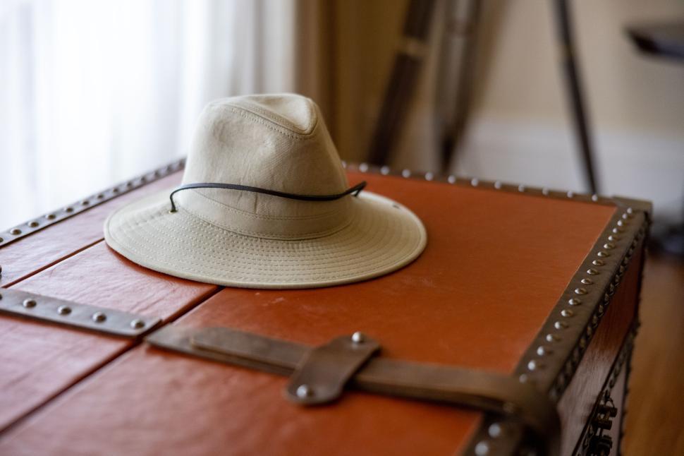 Free Image of Explorer’s hat resting on vintage travel chest 