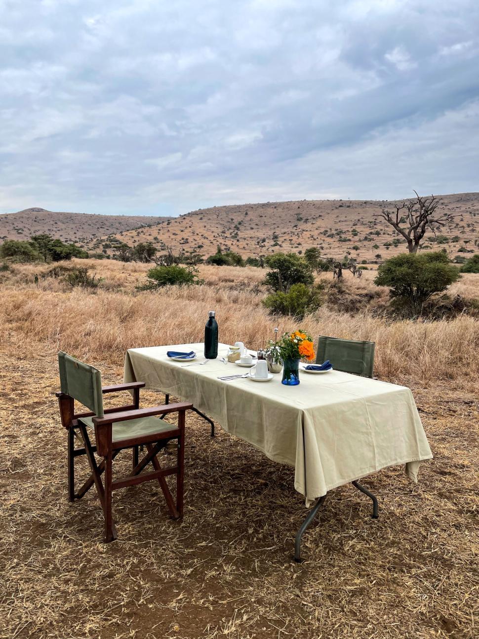 Free Image of Outdoor table set for two in an arid grassland area. 