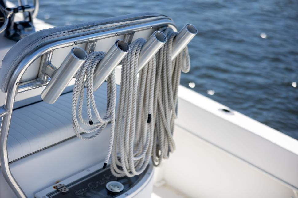Free Image of Nautical ropes neatly arranged on a boat near water. 