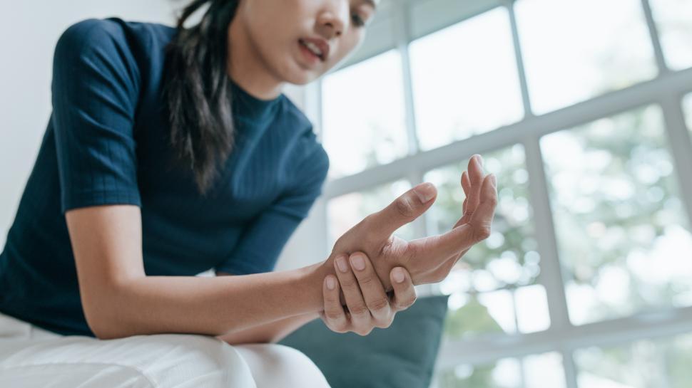 Free Image of Unhappy Asian woman suffering from pain in arm 