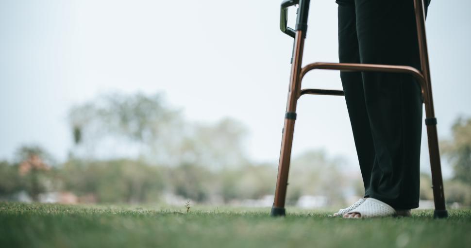 Free Image of Mature Asian woman uses a support device while training to walk 