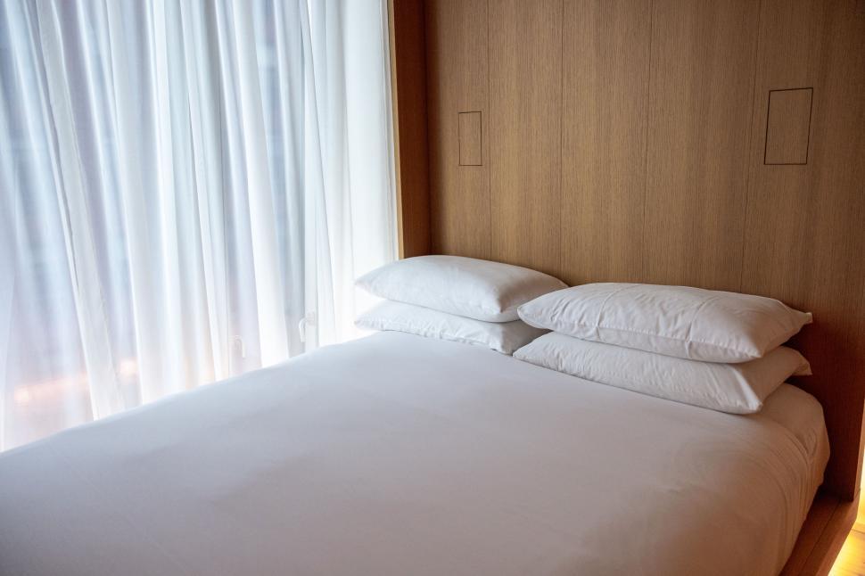 Free Image of Minimalist bedroom with large window and natural light. 
