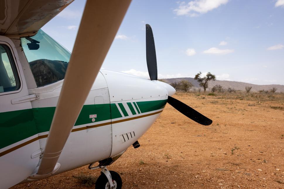 Free Image of Small aircraft parked in open area with clear skies. 