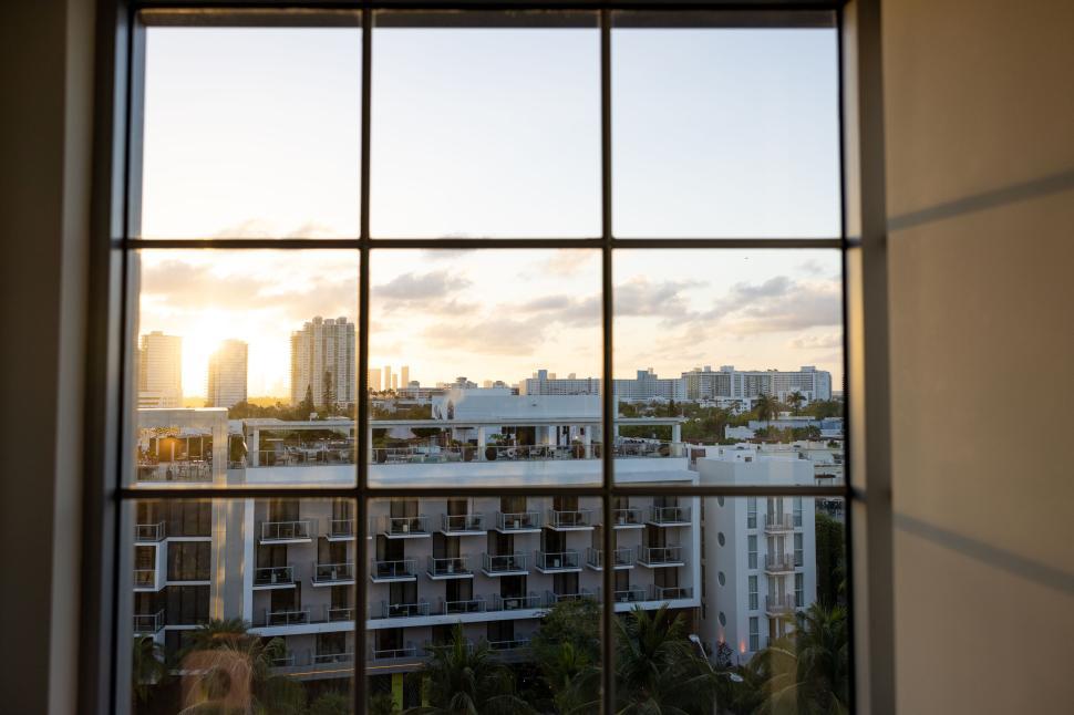 Free Image of Urban cityscape at sunrise viewed through modern window. 