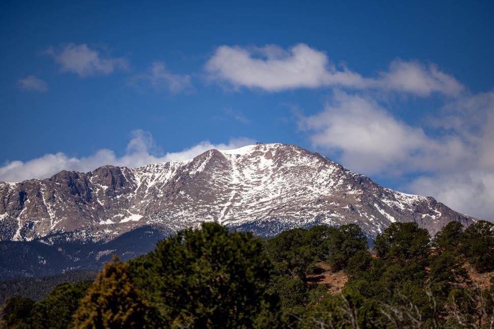 Free Image of Snow-capped mountain peak against a clear blue sky 