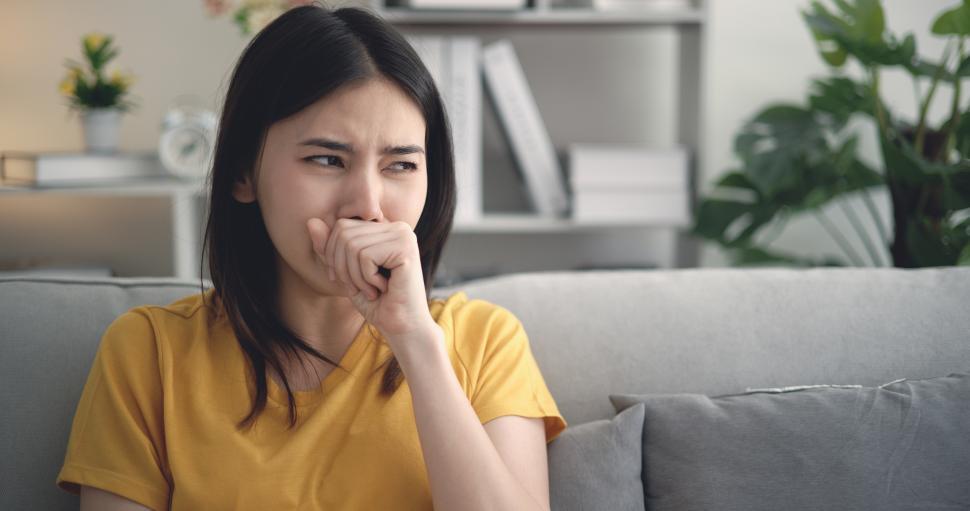 Free Image of Young Asian woman suffering from flu, coughing and sneezing at home 