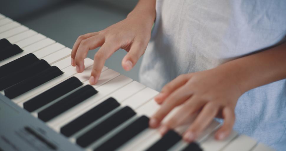 Free Image of Cute boy enjoy to learning playing piano at home 