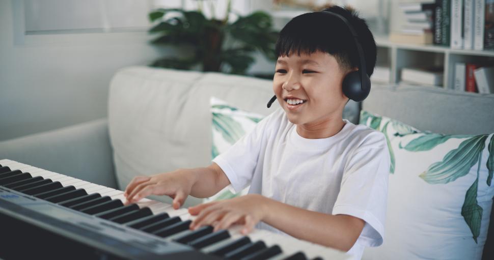Free Image of Cute boy enjoy to learning playing piano at home 
