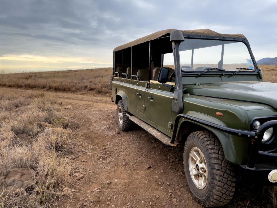 Free Image of Off-road vehicle positioned on a wide open terrain road. 