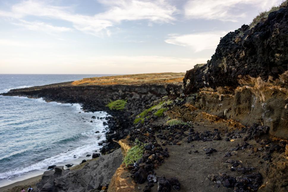 Free Image of Rocky coastline with ocean waves and cliffs at sunrise 