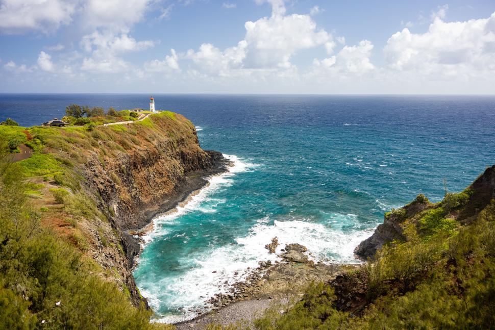 Free Image of Cliffside lighthouse overlooking the pristine coastline 