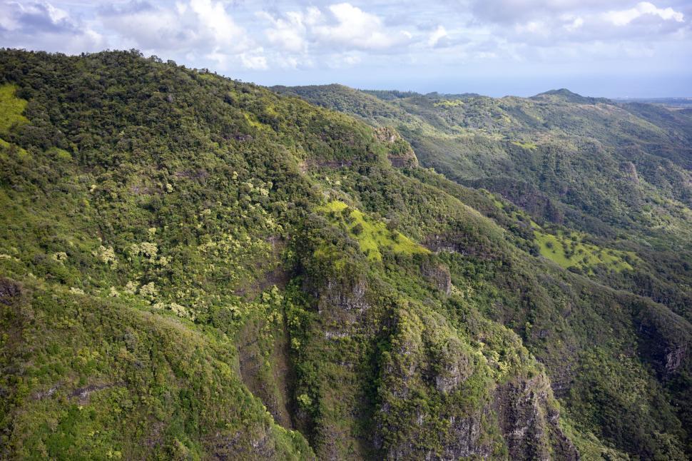 Free Image of Lush green mountain landscape under partly cloudy sky 