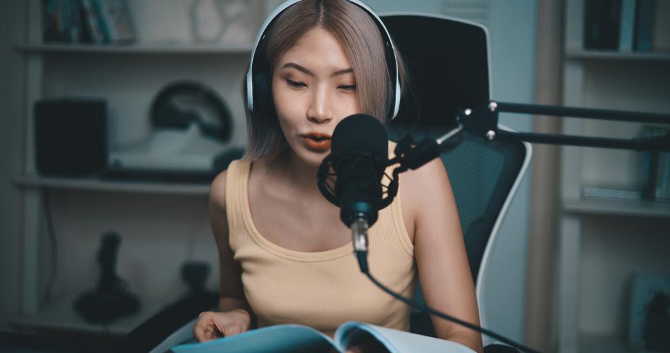 Free Image of Cheerful Young podcaster on the microphone during online podcast in studio 