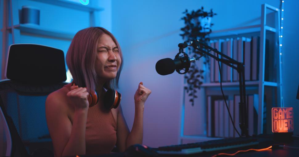 Free Image of Asian young Esport woman gamer frustrated playing online game on pc 