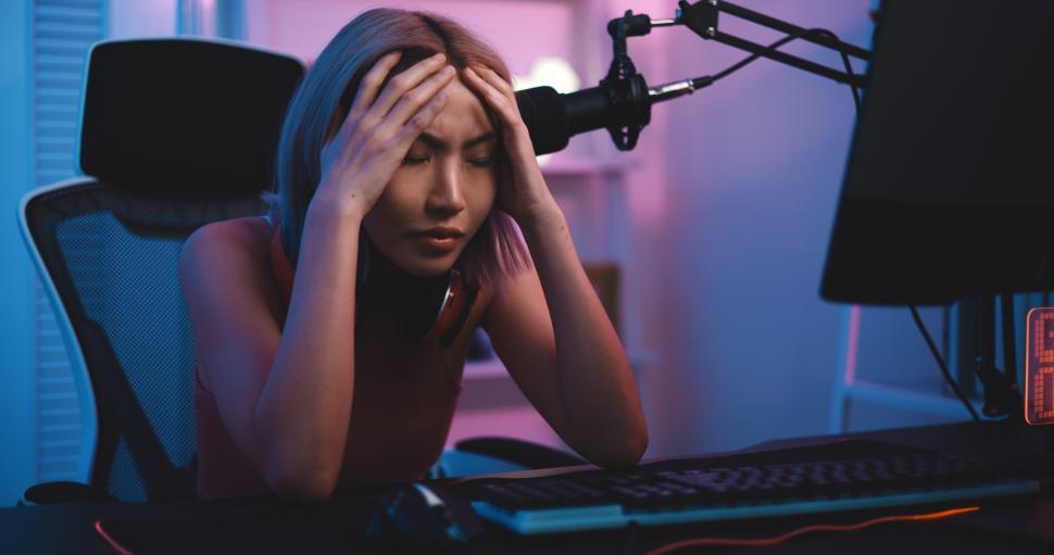 Free Image of Young Esport woman gamer play online game on PC feel upset 
