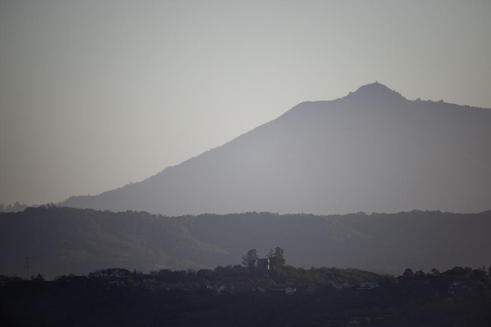 Free Image of Distant view of mountain with trees in foreground. 