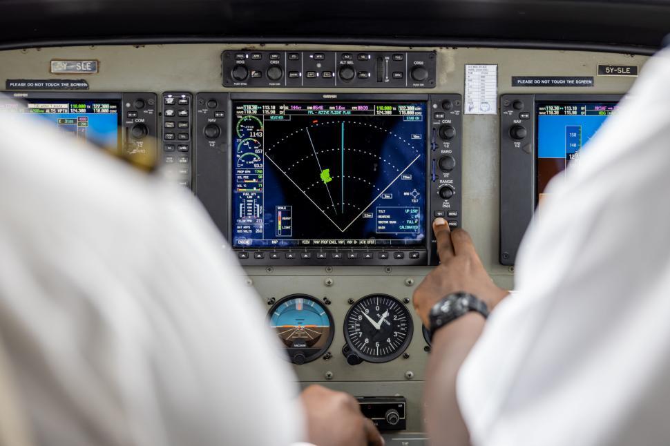Free Image of Pilots in cockpit navigating with modern flight instruments. 