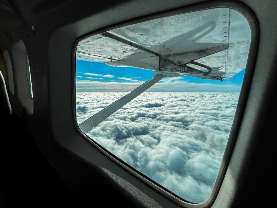 Free Image of View from airplane window showing vast cloudscape scenery 