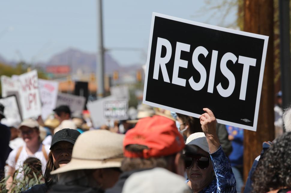 Free Image of Political protest featuring Resist signs and demonstrations against Donald Trump in the United States during a sunny day 