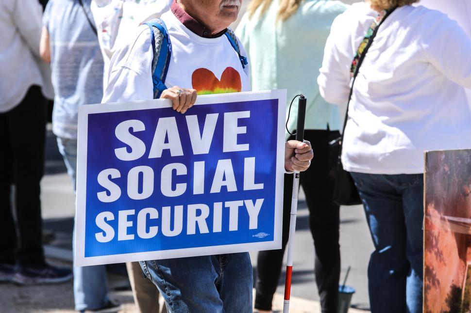 Free Image of Save Social Security sign at protest against political policies and supporting social security in the United States 