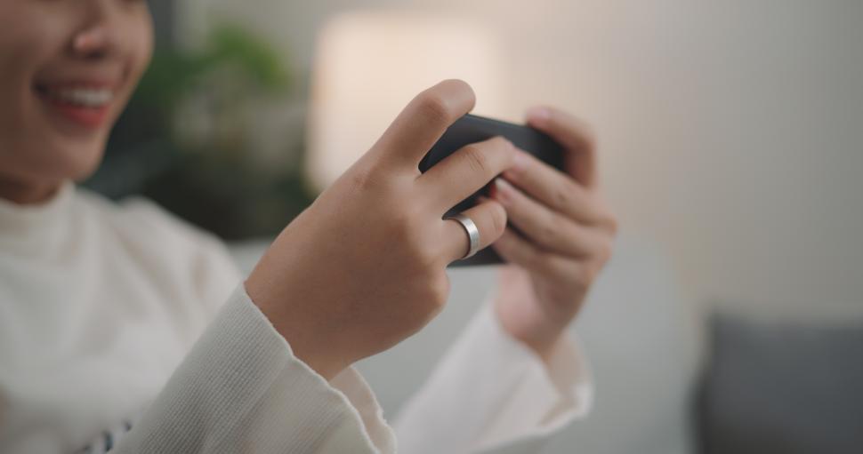 Free Image of Asian woman playing a game on smartphone 
