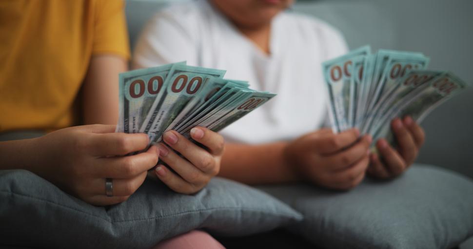 Free Image of Portrait close up of young women and teen girl counting cash money on sofa in the living room at home,Happy counting dollars banknote. 