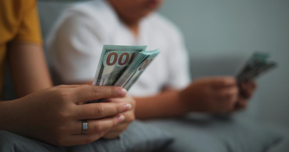 Free Image of Portrait close up of young women and teen girl counting cash money on sofa in the living room at home,Happy counting dollars banknote. 