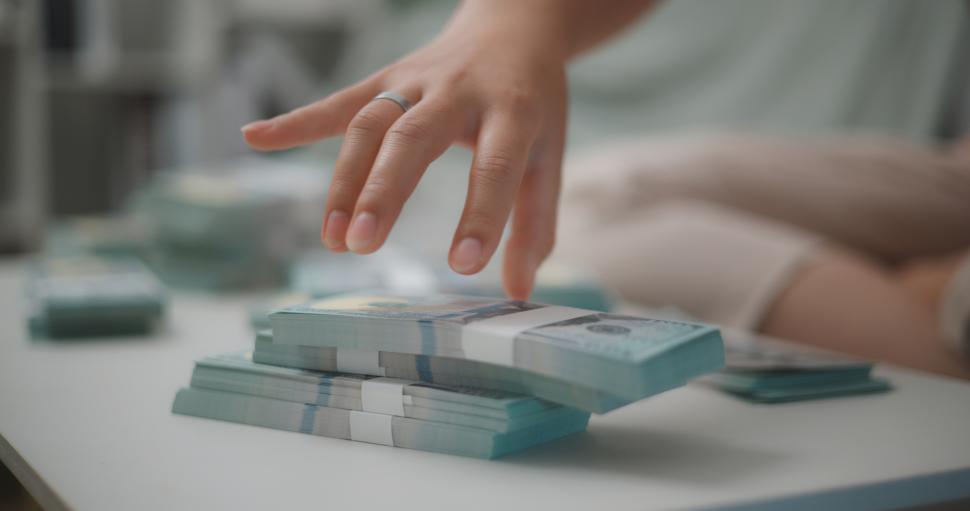 Free Image of Portrait close up of young asian woman counts cash dollar bills while sitting in living room at home,counting stack cash money dollar, Financial planning. 