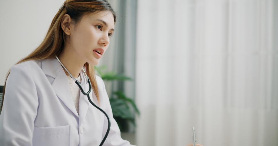 Free Image of Portrait of Asian doctor explains health problem of young female patient in clinic office, Health and medicine consultant, conversation about healthcare 