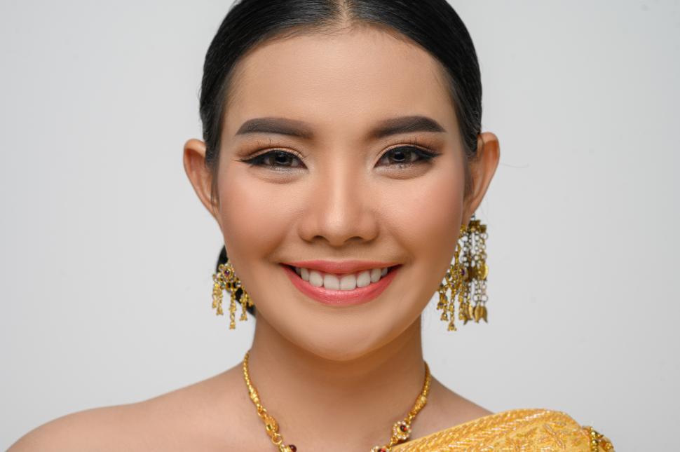 Free Image of Beautiful Asian woman in traditional Thai dress costume white background 