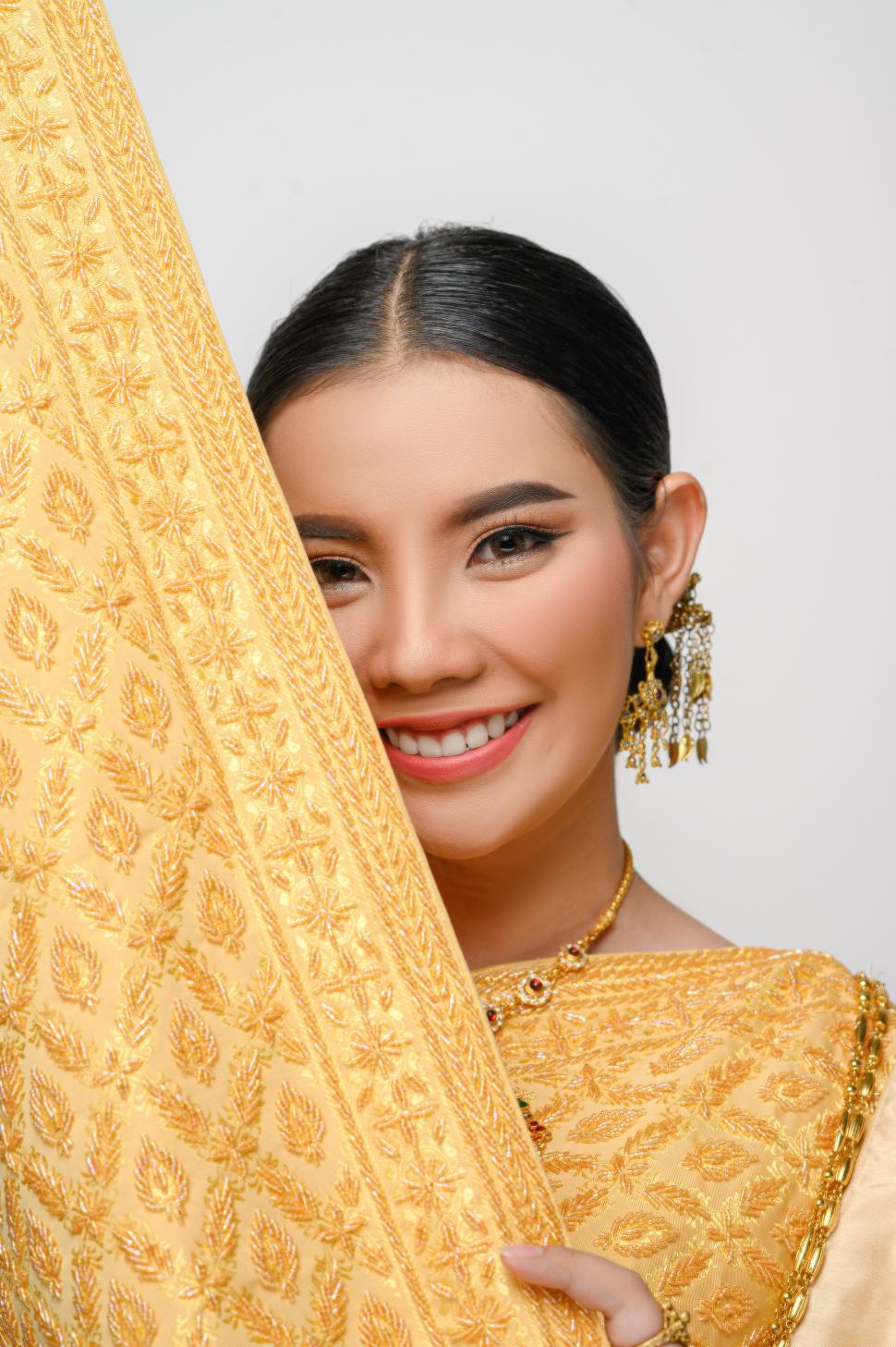 Free Image of Beautiful Asian woman in traditional Thai dress costume white background 