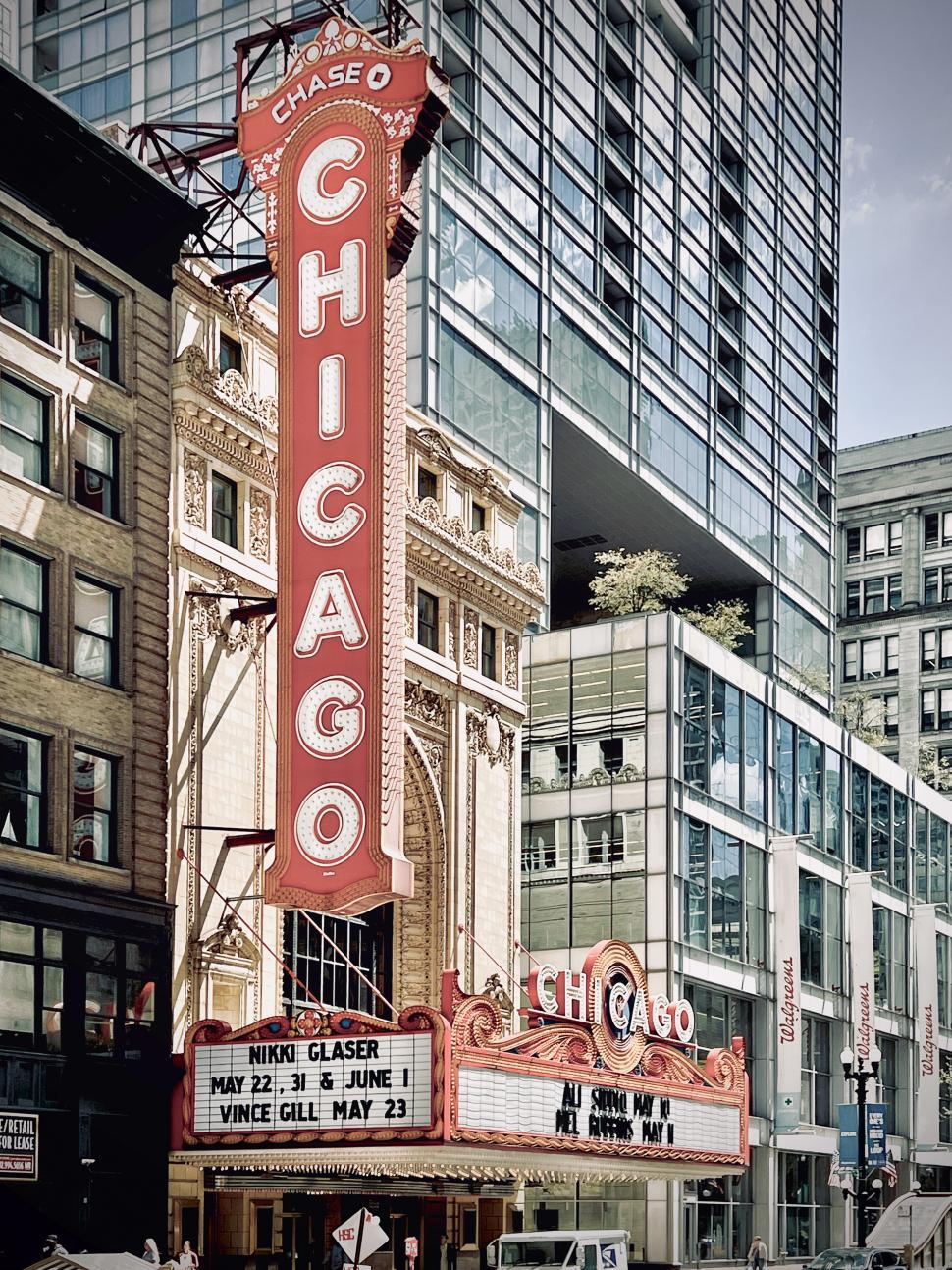 Free Image of Historic Chase Theater in Chicago showcasing vibrant architecture with a focus on its iconic marquee and bustling surroundings 