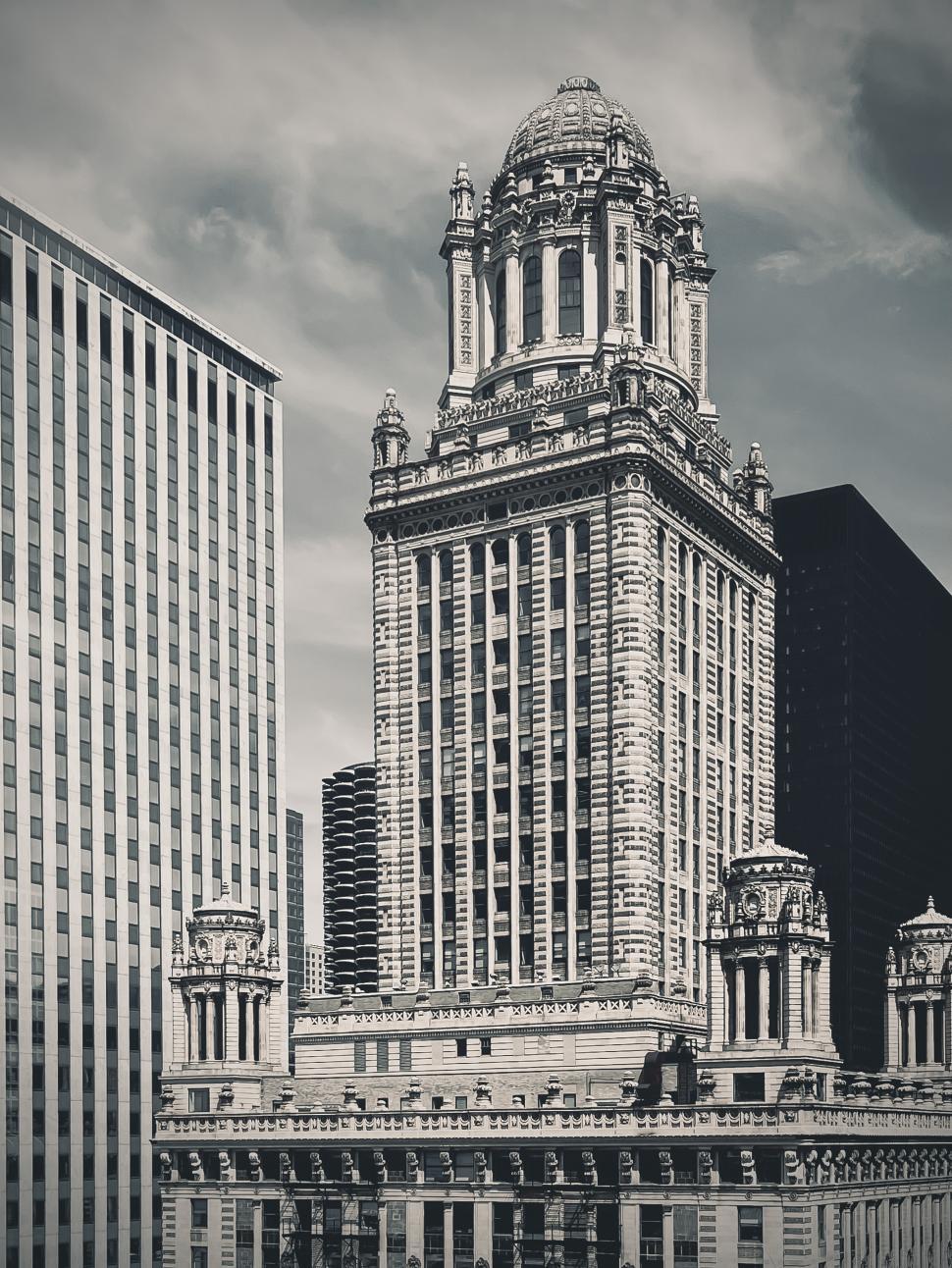 Free Image of Tall historic Jewelers building featuring ornate architectural details surrounded by modern skyscrapers in an urban setting 