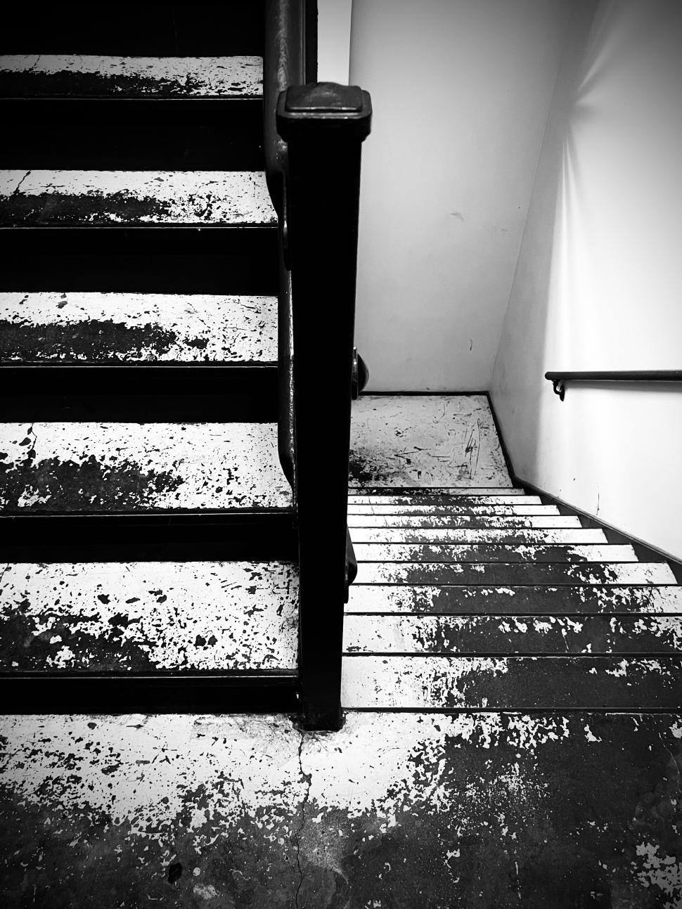 Free Image of Stairs in an old building with worn steps and monochrome aesthetic 