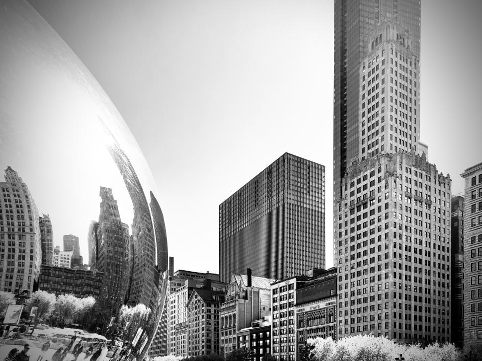 Free Image of Reflections of Chicago in the Bean, black and white, showcasing urban architecture and skyline features. 