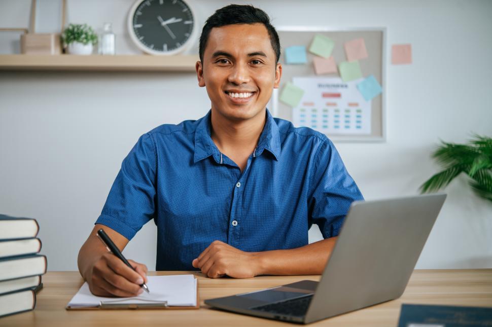 Free Image of A man working in office with papers 