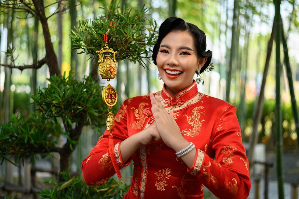 Free Image of Asian woman with Golden amulet for Chinese New Year lucky symbol decorations 