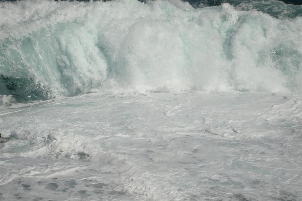 Free Image of Man Riding Wave on Surfboard 