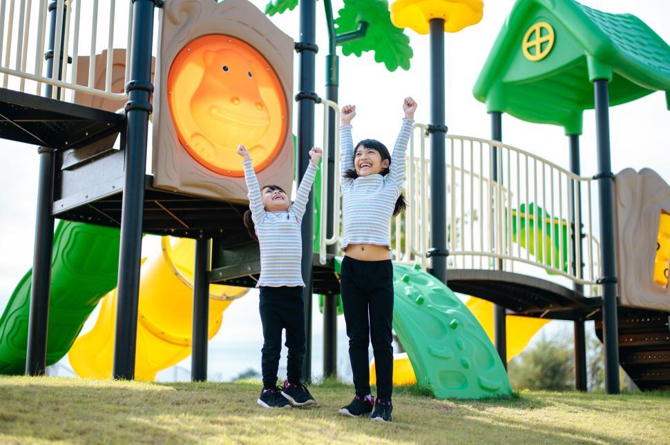 Free Image of two girls playing in the playground. 